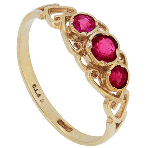 A 9ct yellow gold, ruby set, three stone ring
