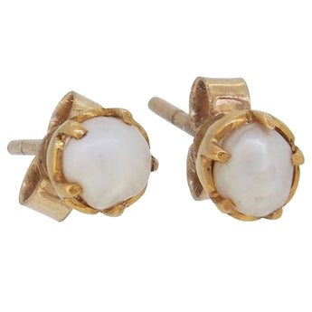 A pair of mid-20th century, yellow gold, pearl set button stud earrings.