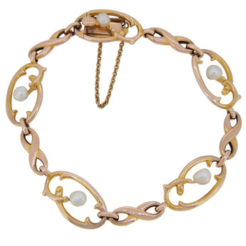 An Edwardian, 10ct yellow gold, Art Nouveau style, pearl set, abstract link bracelet.