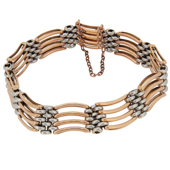 An early 20th century, 15ct rose gold & platinum, four bar gate link bracelet.