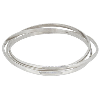 Three modern, silver, intertwined bangles.