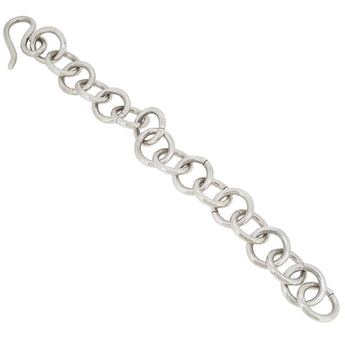 A modern, silver, heavy, circular link bracelet.