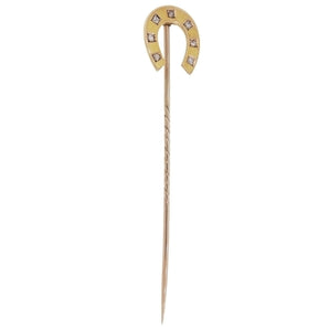 An early 20th century, 9ct yellow gold, rose cut diamond set, seven stone horseshoe stick pin.