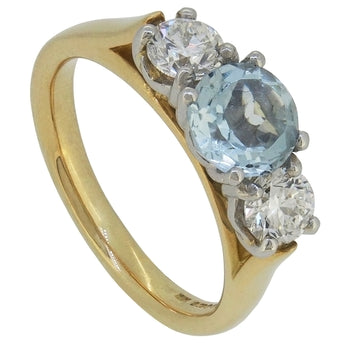 A modern, 14ct yellow gold, aquamarine & diamond set three stone ring.
