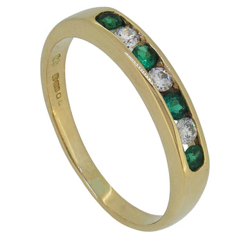 A modern, 18ct yellow gold, emerald & diamond set, seven stone, half eternity ring.