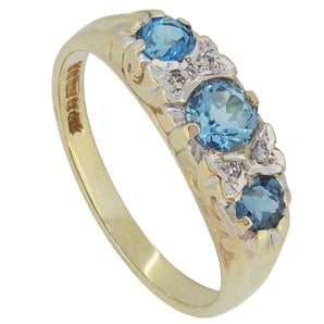 A modern, 9ct yellow gold, blue topaz & diamond set carved half hoop ring.