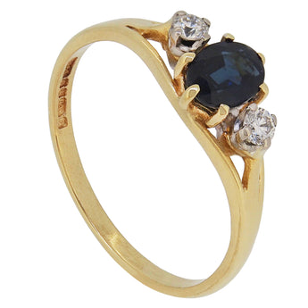 A modern, 18ct yellow gold, sapphire & diamond set three stone ring.
