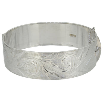 A modern, silver, flat hinged bangle with an engraved foliate design.