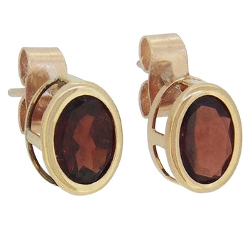 A pair of modern, 9ct yellow gold, garnet set stud earrings.