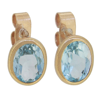 A pair of modern, 9ct yellow gold, blue topaz set stud earrings.