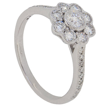 A modern, 18ct white gold, diamond set, nine stone daisy cluster ring.