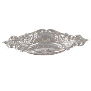 A modern, silver, oval bon bon dish with a scroll & foliate border.