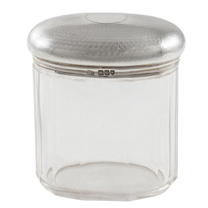 An Edwardian, faceted glass jar with an engine turned silver lid & vacant cartouche.