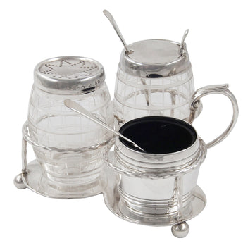 A Victorian, silver & cut glass, three piece bottle cruet on a stand with ball feet, twisted wire borders & a loop handle.