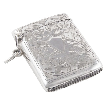 An Edwardian, silver vesta case with a vacant shield cartouche on the front & a floral design on the front & rear.