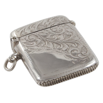 An Edwardian, silver, curved vesta case with floral engraving on the rear & three quarters of the front.