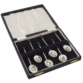 A set of six, modern, silver coffee spoons with coffee bean terminal ends, enamel set bowls with a floral pattern & fitted case.