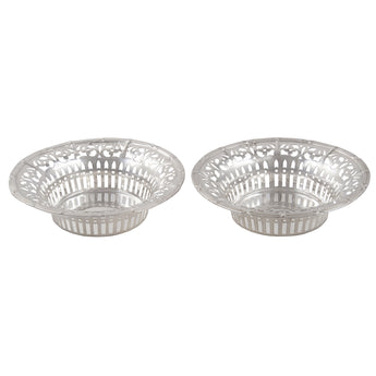 A pair of Edwardian, silver, circular, pierced bon bon dishes with a reed & ribbon decorative edge.