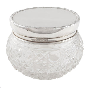An Edwardian, cut glass jar with a silver lid.