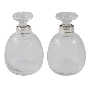 A pair of modern, engraved glass scent bottles with silver mounts & cut glass stoppers.
