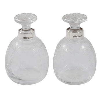 A pair of modern, cut glass scent bottles with silver mounts & glass stoppers