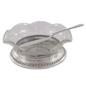 A silver butter dish with a floral engraved & frilled glass bowl, with a silver butter knife.