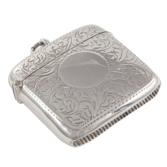 An Edwardian, silver, curved vesta case with a vacant circular cartouche & floral decoration front & back.