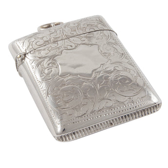 A Victorian, silver vesta case with a vacant shield cartouche & floral decoration on front & back sides.