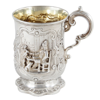 A Victorian, silver tankard with a figure in relief of a person & fruit & a gilt interior