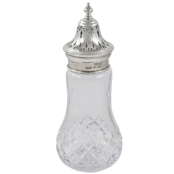 A modern, glass sugar dredger with a silver lid.