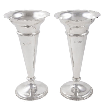 A pair of Edwardian, silver trumpet vases with scalloped rims.