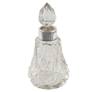 An Edwardian, cut glass scent bottle with a silver mount & faceted glass stopper.