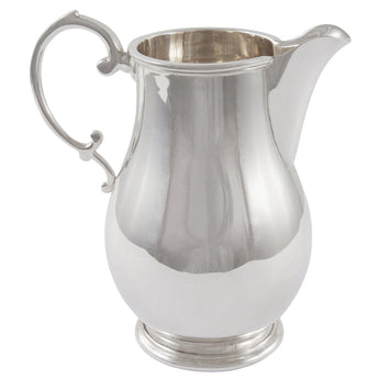 A modern, silver, cream jug.