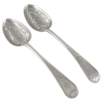 A pair of Georgian, silver tablespoons with ornate floral & foliate engraving to the bowls & handles.