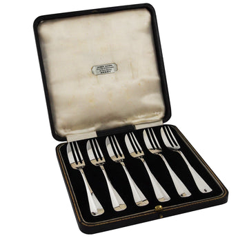 Six early 20th century, silver, rattail pastry forks & fitted case.