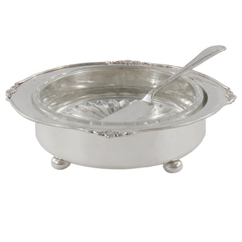 An Edwardian, silver, circulare butter dish on four ball feet, with a glass liner & butter knife.