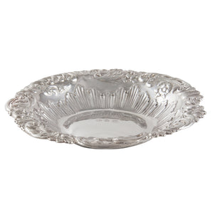 A Victorian, silver, circular, embossed dish with a scroll & shell border.