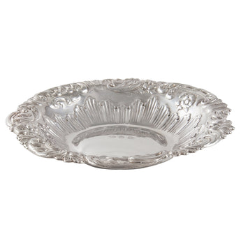 A Victorian, silver, circular, embossed dish with a scroll & shell border.