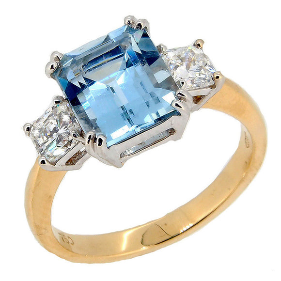 A modern, 18ct yellow gold, aquamarine & diamond set three stone ring