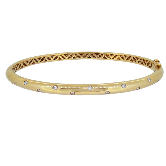 A modern, 18ct yellow gold, diamond set scatter bangle