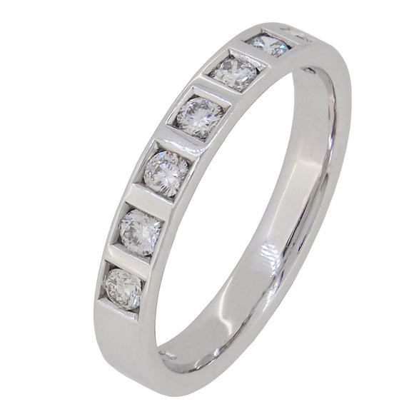 A modern, 9ct white gold, diamond set, seven stone half eternity ring.