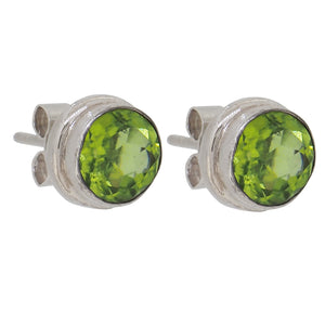 A pair of modern, silver, peridot set stud earrings