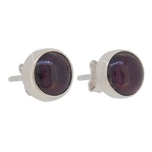 A pair of modern, silver, garnet set stud earrings