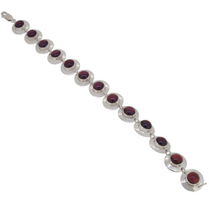 A modern, silver, garnet set bracelet