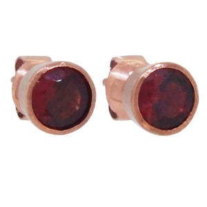 A pair of modern, 9ct rose gold, garnet set stud earrings