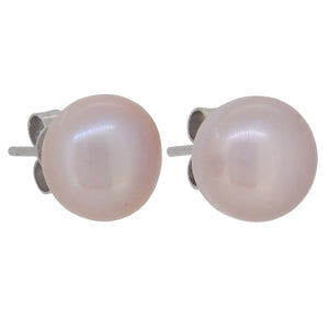 A pair of modern, silver, pearl set stud earrings