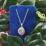 A modern, silver, engraved, oval locket &amp; chain.