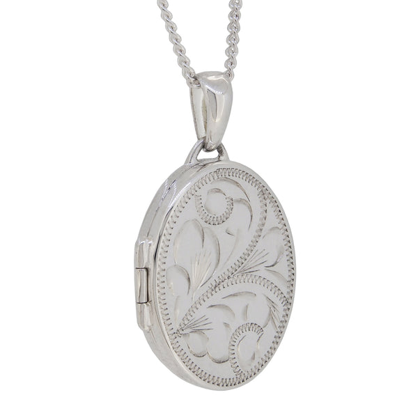A modern, silver, engraved, oval locket & chain