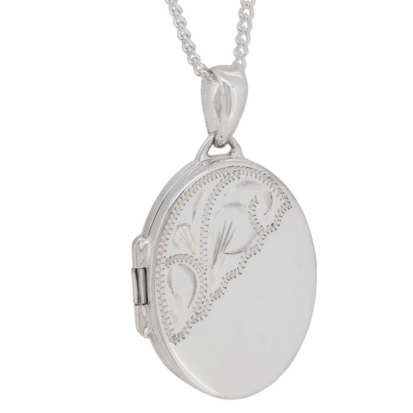 A modern, silver, partially engraved, oval locket & chain