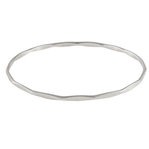 A modern, silver, faceted bangle